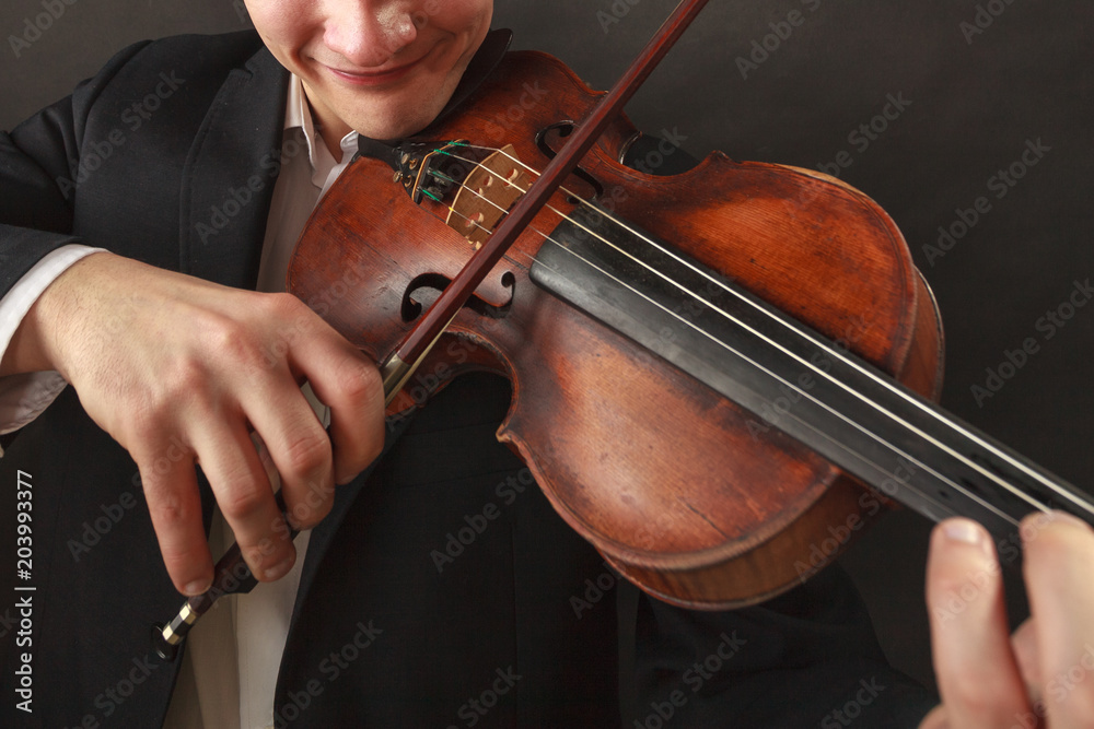 Man playing violin showing emotions and expressions Man playing violin showing emotions and expressions