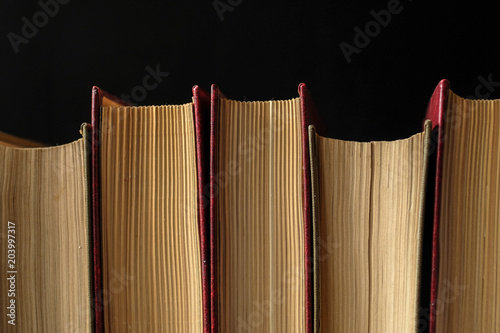 horizontal stack of books on black background