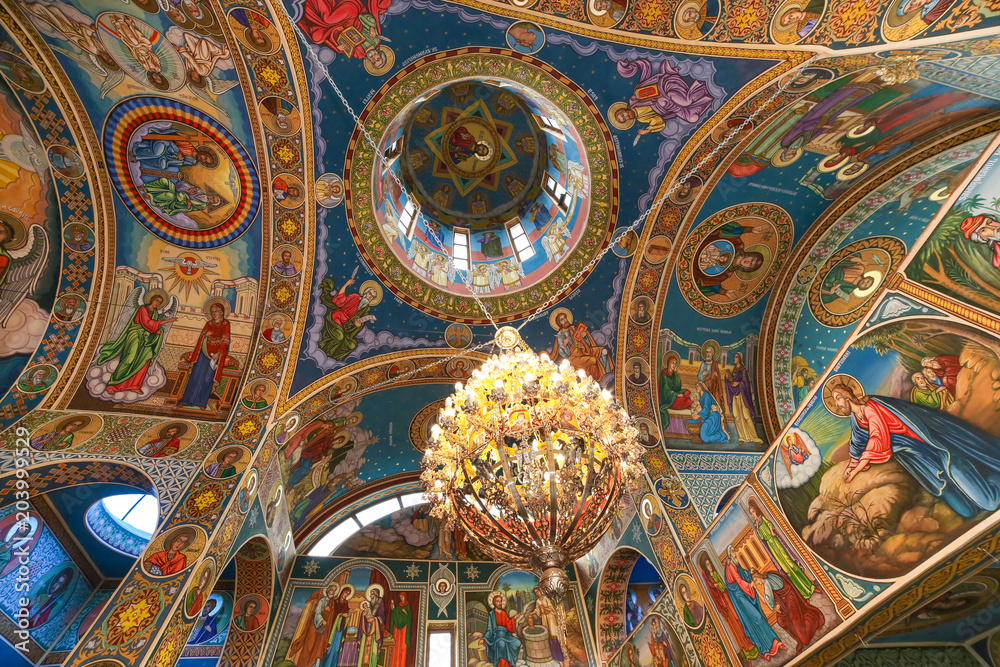 Orthodox church ceiling with fresco and chadelier