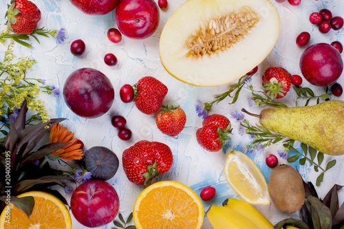 Different fruits on a light background. Vitamins and diet. Summer berries and fruits. Healthy food. Background