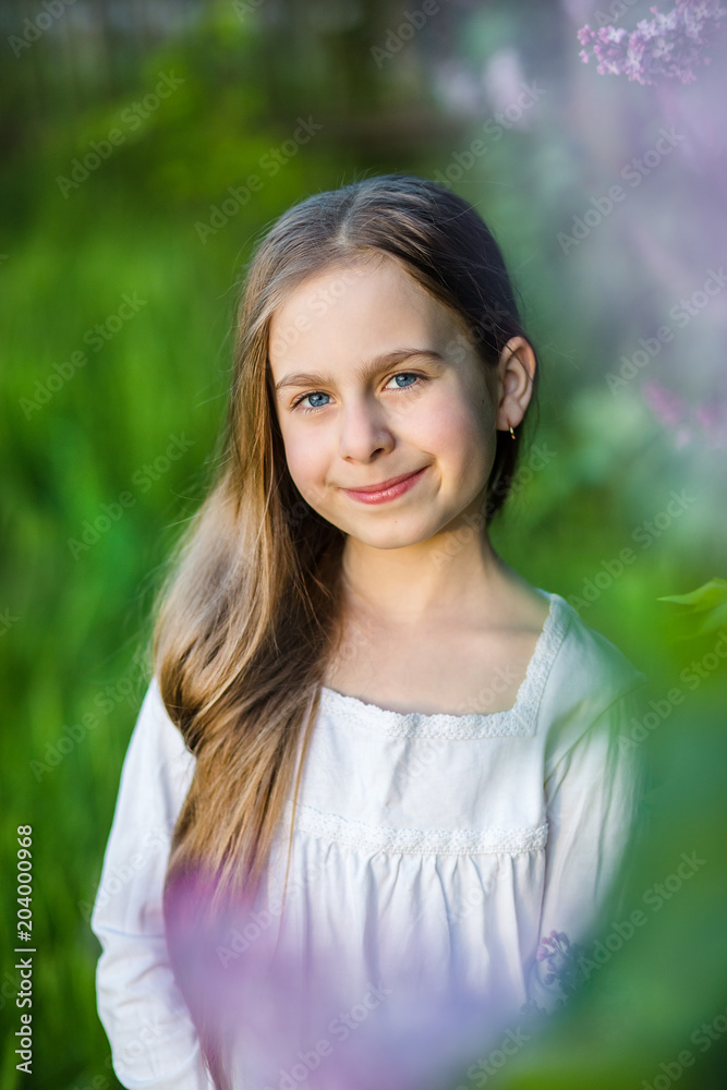 Portrait of cute girl in the spring garden