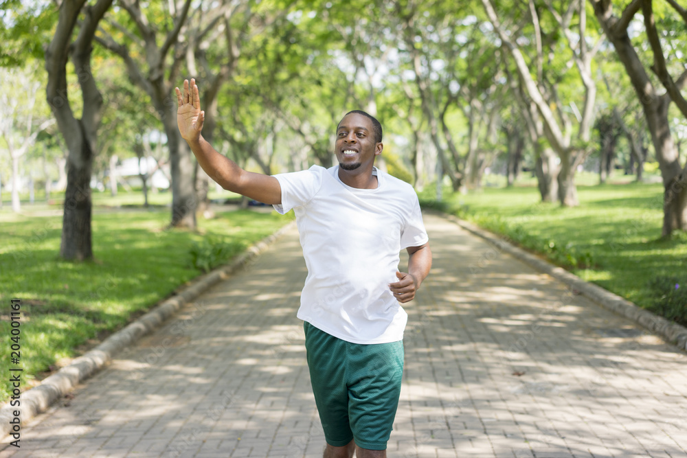 Sporty man jogging in a park stock photo