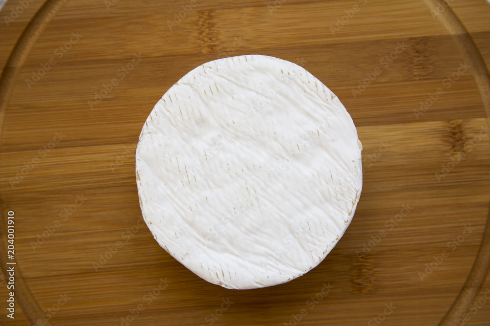 Cheese camembert on bamboo board. Food for wine. From above. Top view. Cheese camembert on bamboo board. Food for wine. From above. Top view.