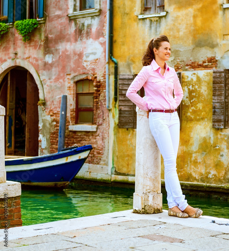 Young woman standing on street in venice, italy