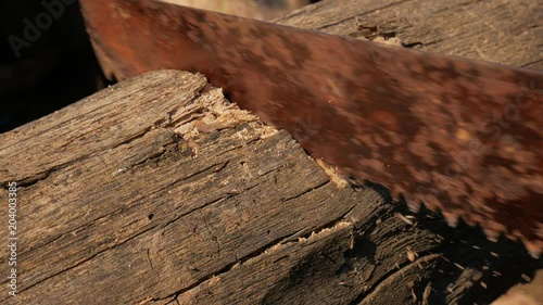 Wallpaper Mural Man saws wooden bar rusty hand saw Torontodigital.ca