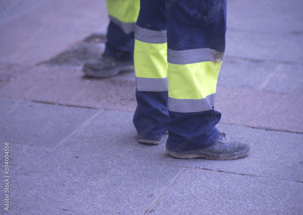 Municipal workers on sidewalk pavement
