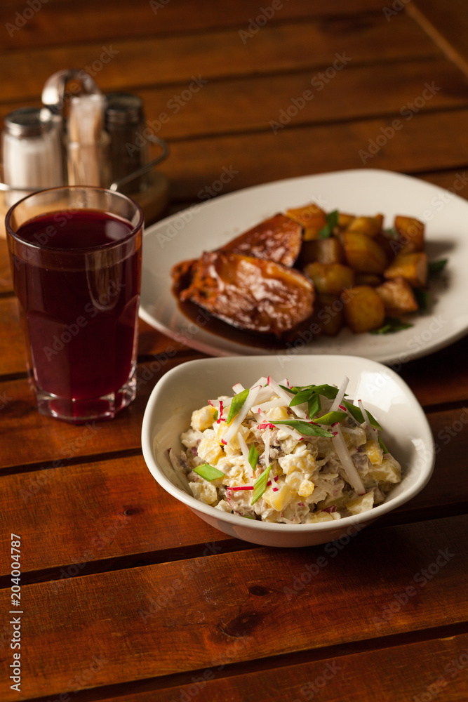 lunch with grilled fish with potatoes, salad and beer lunch with grilled fish with potatoes, salad and beer