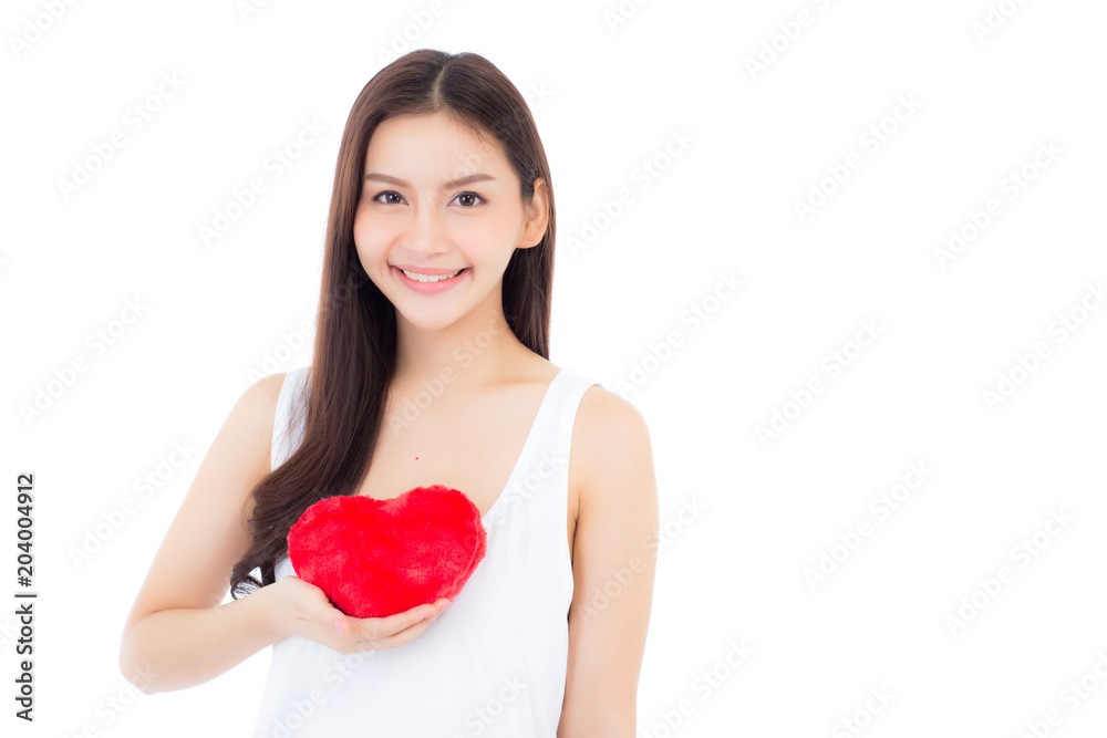 Portrait of beautiful asian young woman holding red heart shape pillow and smile isolated on white background, valentines day, holiday concept. Portrait of beautiful asian young woman holding red heart shape pillow and smile isolated on white background, valentines day, holiday concept.