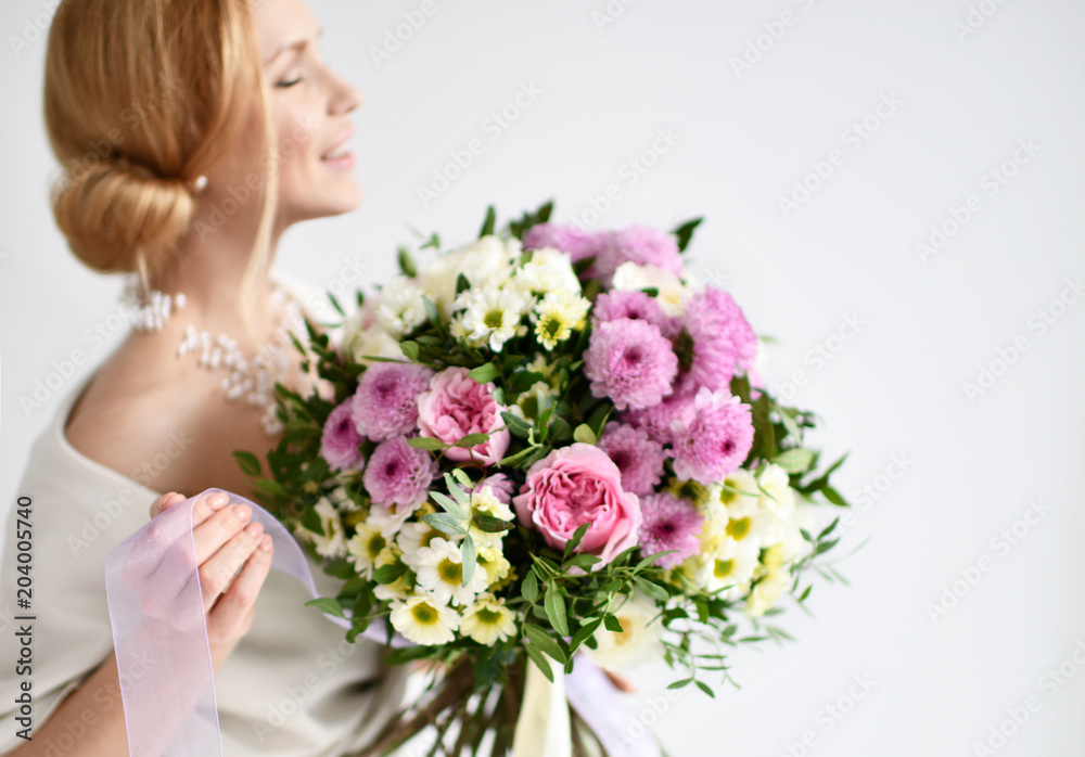 Beautiful woman hold bouquet of chrysanthemum and roses flowers white and purple happy smiling on grey Beautiful woman hold bouquet of chrysanthemum and roses flowers white and purple happy smiling on grey
