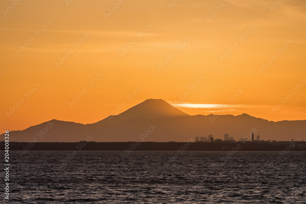 Mountain Fuji and Tokyo bay at sunset time in winter season.Tokyo Bay is a bay located in the southern Kanto region of Japan, and spans the coasts of Tokyo, Kanagawa Prefecture, and Chiba Prefecture.