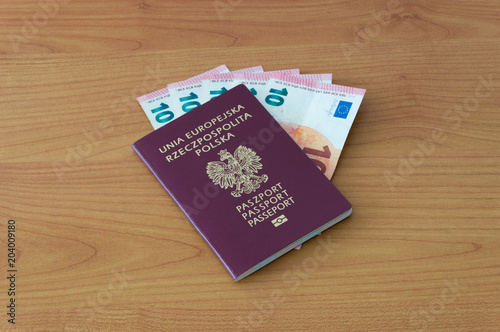 Polish biometric passport with five 10 euro banknotes.