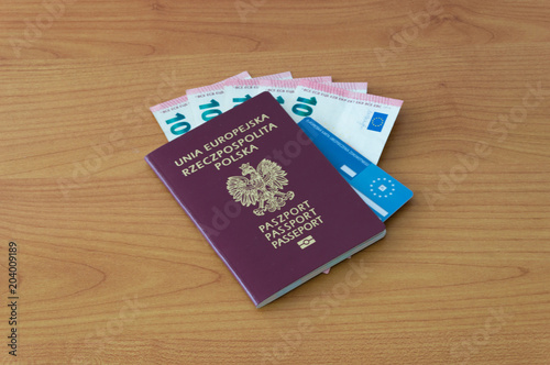 Polish biometric passport with five 10 euro banknotes and European Health Insurance Card knows in Poland as EKUZ.