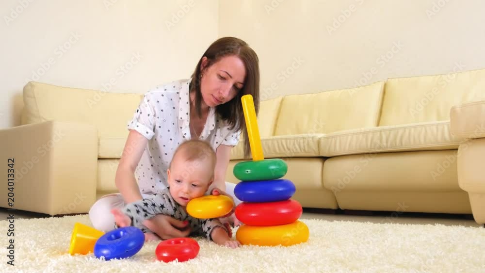 Cute mother and child boy play together indoors at home. Loving mom and baby toddler playing and having fun time together. Cute mother and child boy play together indoors at home. Loving mom and baby toddler playing and having fun time together.