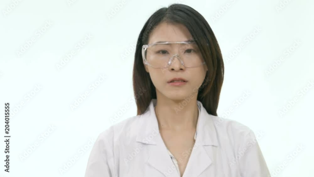 Asian female wearing lab coat and safety glasses scanning with eyes