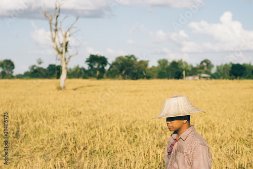 Brown Skin Farmer And His Rice Field  © Phoomin