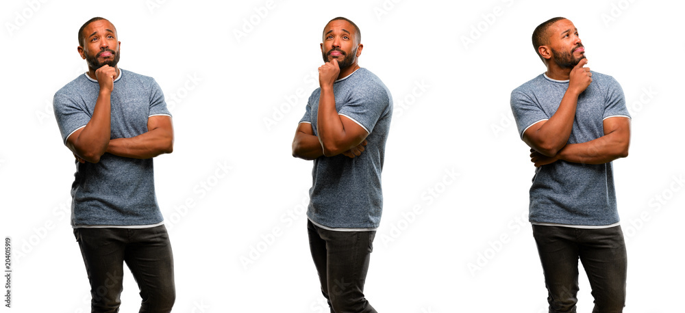Obraz premium African american man with beard thinking and looking up expressing doubt and wonder