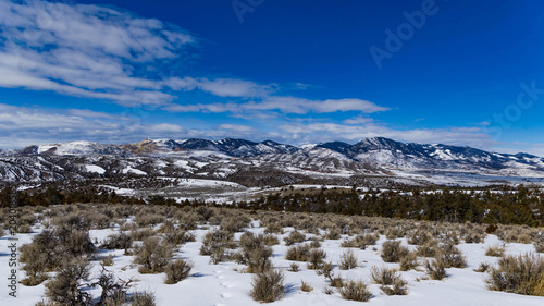 Snow capped mountain in Montana with blue sky and clouds.