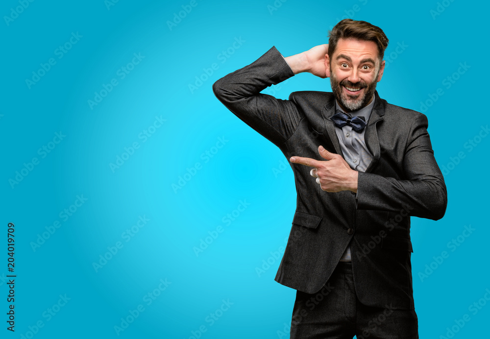 Middle age man, with beard and bow tie pointing away side with finger Middle age man, with beard and bow tie pointing away side with finger