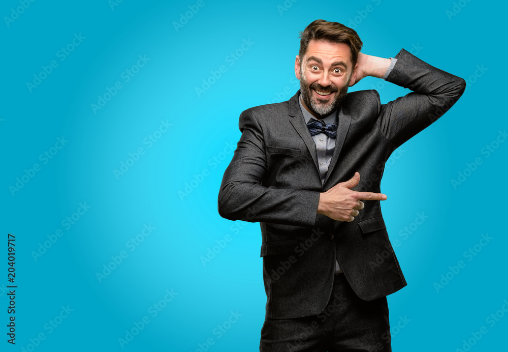 Middle age man, with beard and bow tie pointing away side with finger Middle age man, with beard and bow tie pointing away side with finger