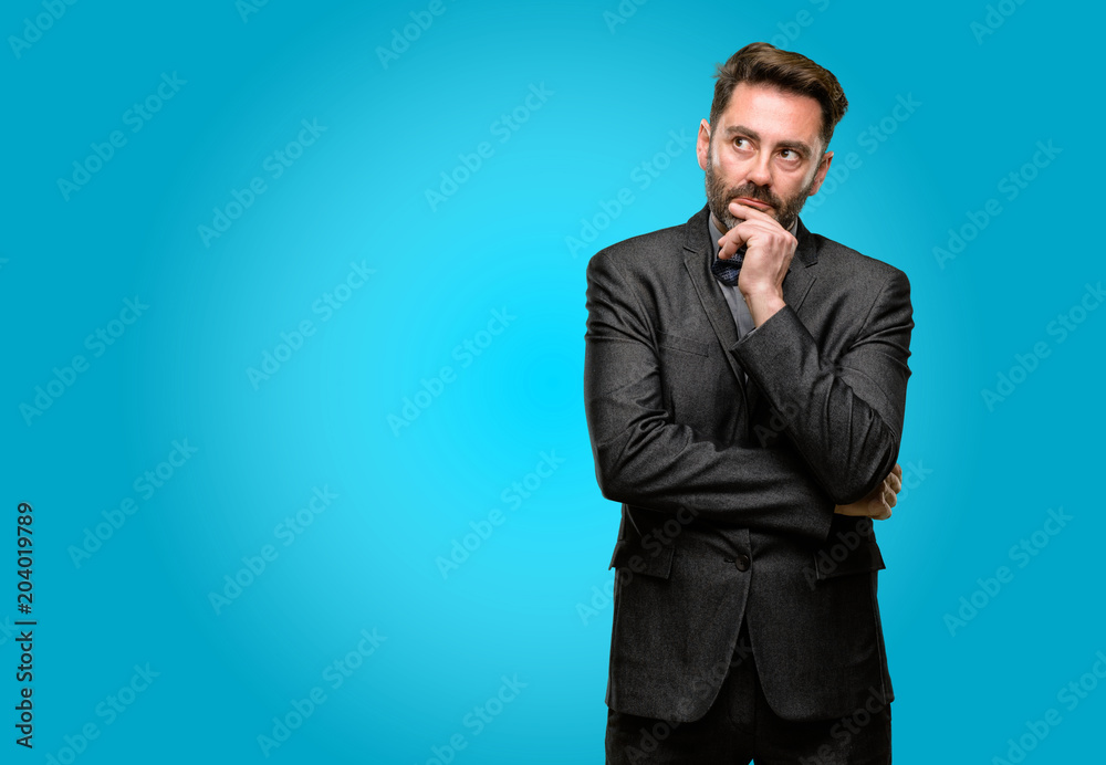 Middle age man, with beard and bow tie doubt expression, confuse and wonder concept, uncertain future Middle age man, with beard and bow tie doubt expression, confuse and wonder concept, uncertain future