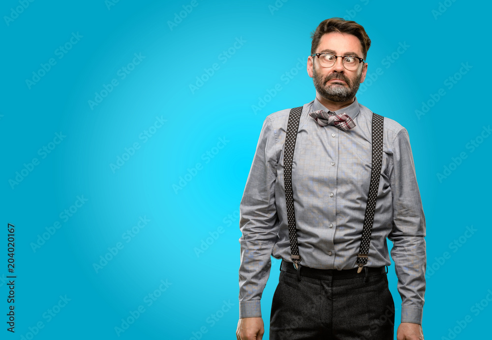 Obraz premium Middle age man, with beard and bow tie making funny face fooling