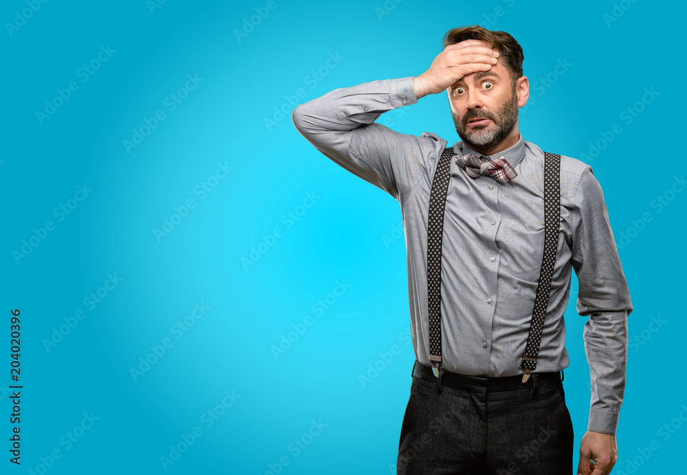Middle age man, with beard and bow tie terrified and nervous expressing anxiety and panic gesture, overwhelmed Middle age man, with beard and bow tie terrified and nervous expressing anxiety and panic gesture, overwhelmed