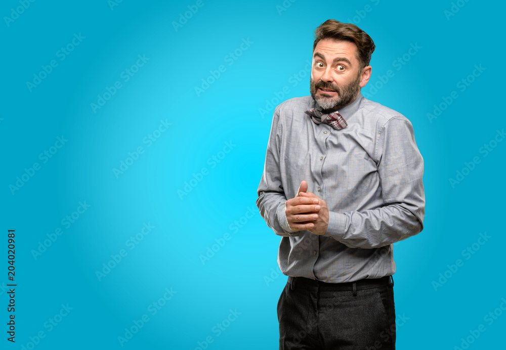 Middle age man, with beard and bow tie confident and happy with a big natural smile Middle age man, with beard and bow tie confident and happy with a big natural smile