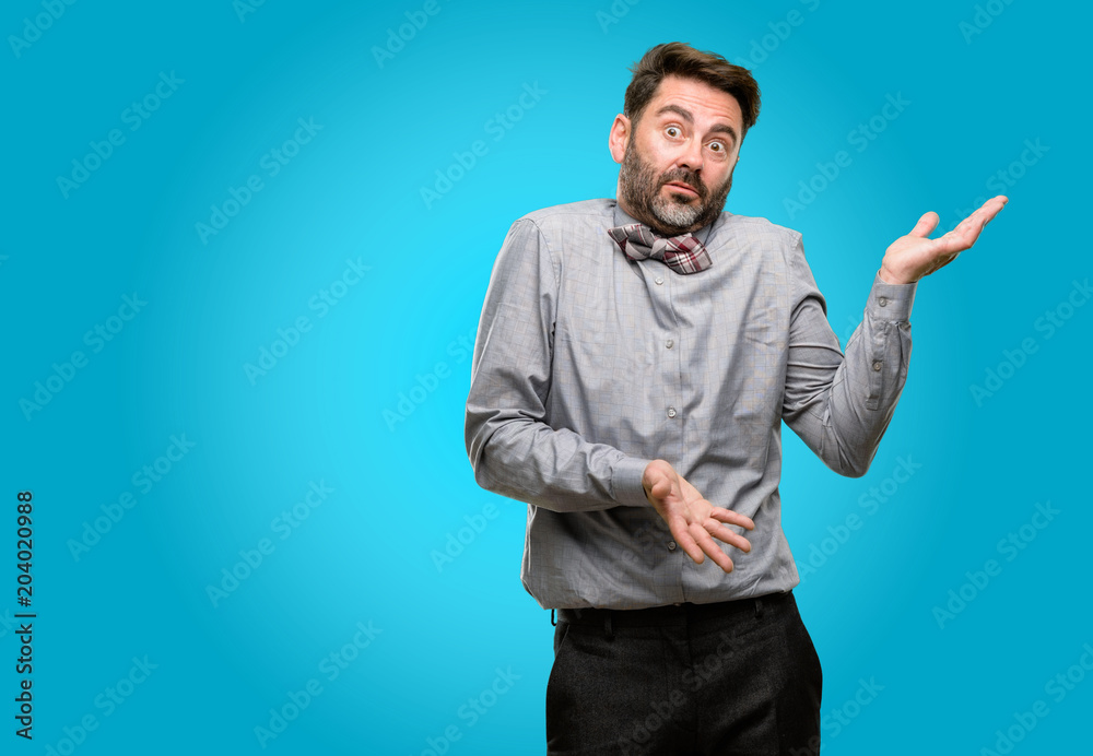 Middle age man, with beard and bow tie doubt expression, confuse and wonder concept, uncertain future Middle age man, with beard and bow tie doubt expression, confuse and wonder concept, uncertain future