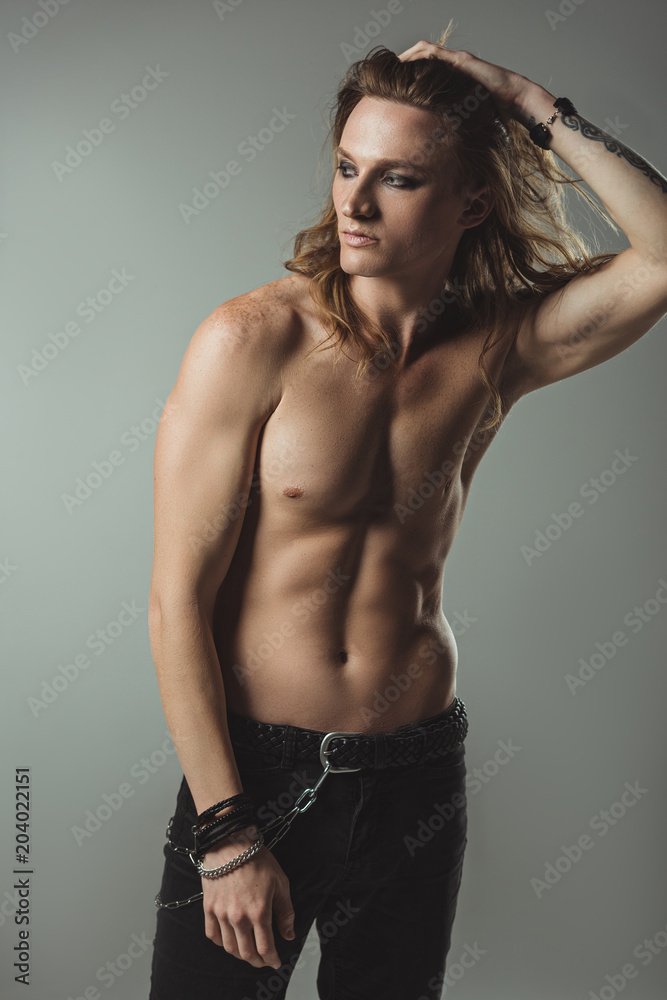 shirtless sexy man with long hair posing in black jeans, on grey Stock  Photo | Adobe Stock