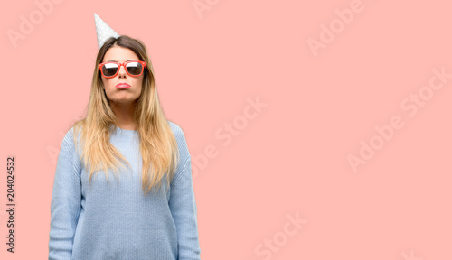 Tableau sur toile Young woman celebrates birthday with sleepy expression, being overworked and tir