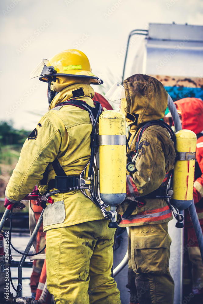 Fototapeta premium Firemen in firefighter uniform preparing equipment and tool.