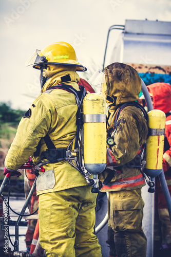 Firemen in firefighter uniform preparing equipment and tool.