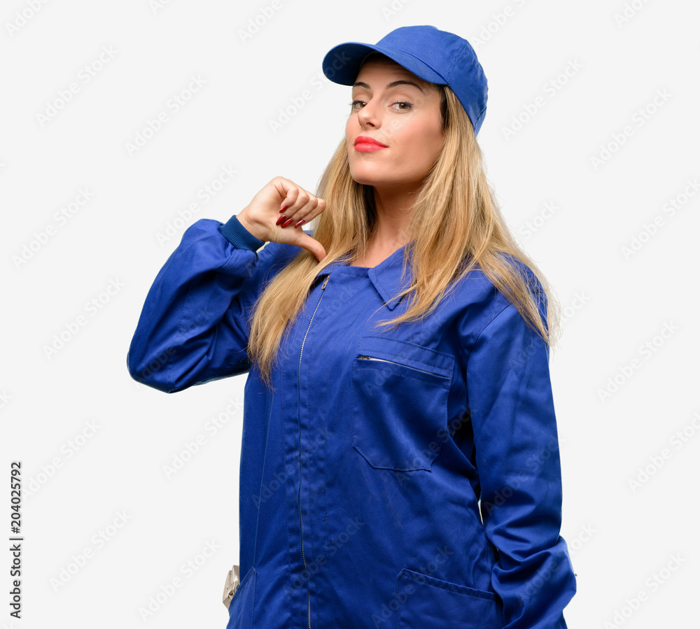 Young plumber woman proud, excited and arrogant, pointing with victory face Young plumber woman proud, excited and arrogant, pointing with victory face