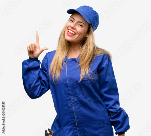 Young plumber woman pointing away side with finger