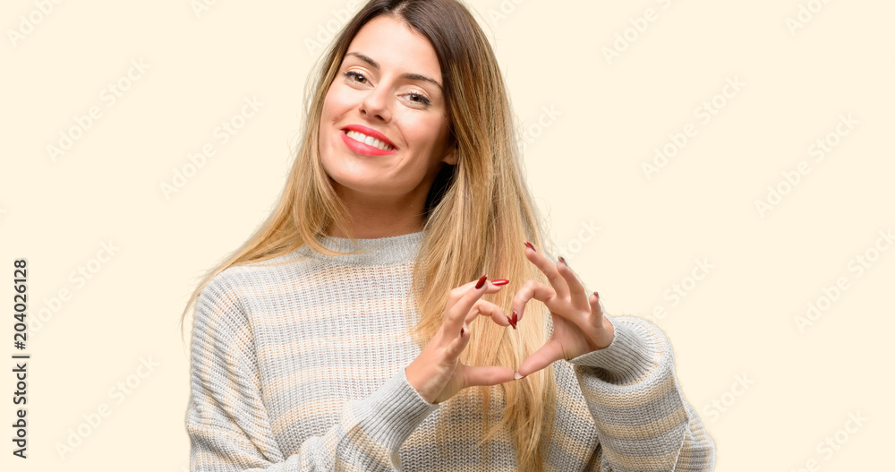 Young beautiful woman happy showing love with hands in heart shape expressing healthy and marriage symbol Young beautiful woman happy showing love with hands in heart shape expressing healthy and marriage symbol