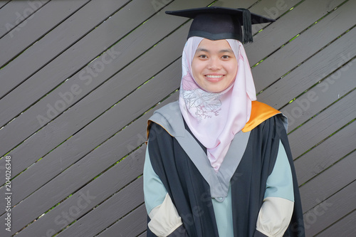 Canvastavla Beautiful female Muslim wearing a convocation robe and posed in happiness style after graduated in University of Canterbury