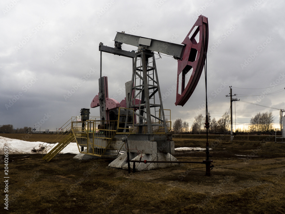 The beam pumping unit is homework, sunset in oil field The beam pumping unit is homework, sunset in oil field