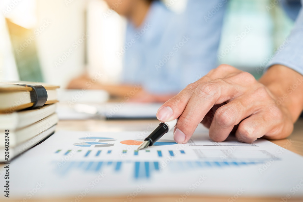 Business team hands at working with plan on office desk and modern digital computer laptop. Administrator financial inspector and secretary making report, calculating balance Business team hands at working with plan on office desk and modern digital computer laptop. Administrator financial inspector and secretary making report, calculating balance