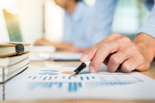 Business team hands at working with plan on office desk and modern digital computer laptop. Administrator financial inspector and secretary making report  calculating balance