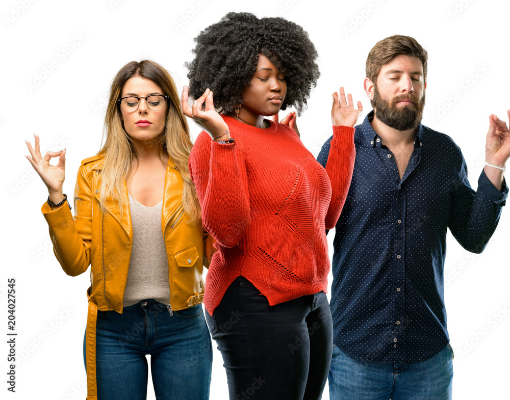 Group of three young men and women doing ok sign gesture with both hands expressing meditation and relaxation Group of three young men and women doing ok sign gesture with both hands expressing meditation and relaxation
