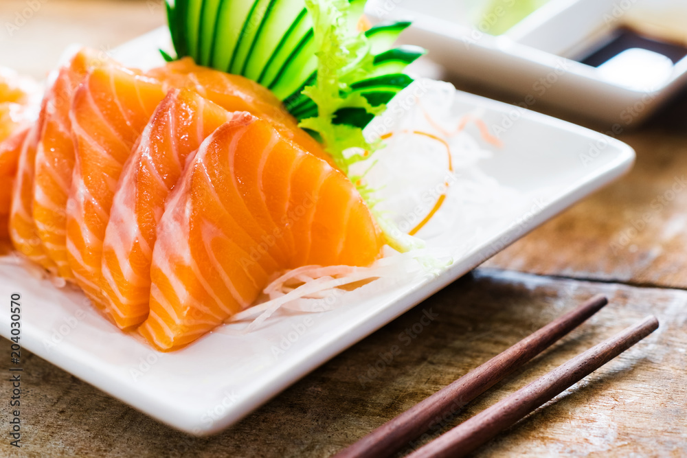 Sashimi, Salmon, Japanese food chopsticks and wasabi on the wood table
Sashimi, Salmon, Japanese food chopsticks and wasabi on the wood table