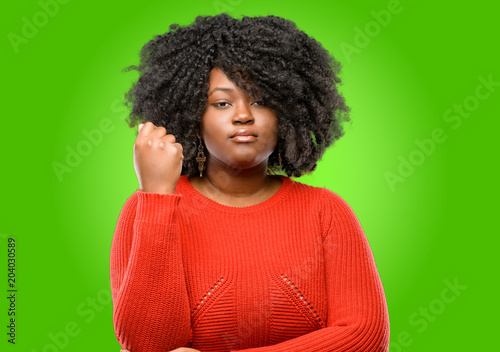 Beautiful african woman with crossed arms confident and serious