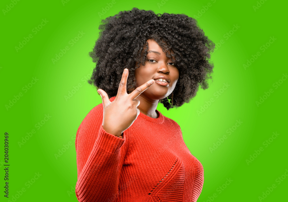 Beautiful african woman raising his finger, is the number three Beautiful african woman raising his finger, is the number three