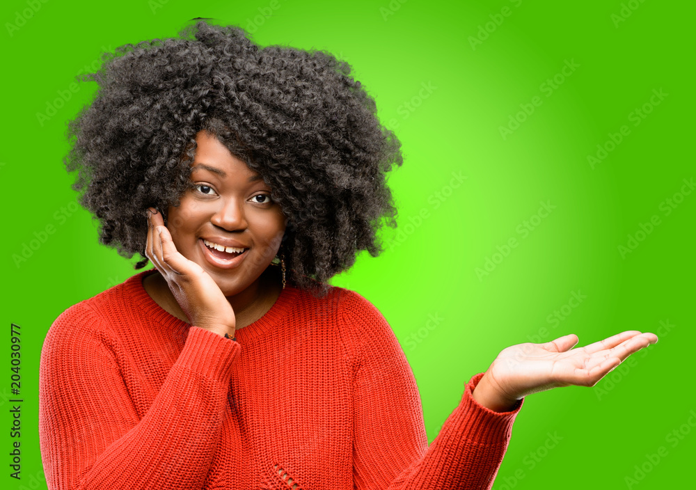 Beautiful african woman holding something in his empty hand Beautiful african woman holding something in his empty hand