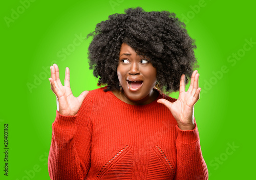 Beautiful african woman terrified and nervous expressing anxiety and panic gesture, overwhelmed