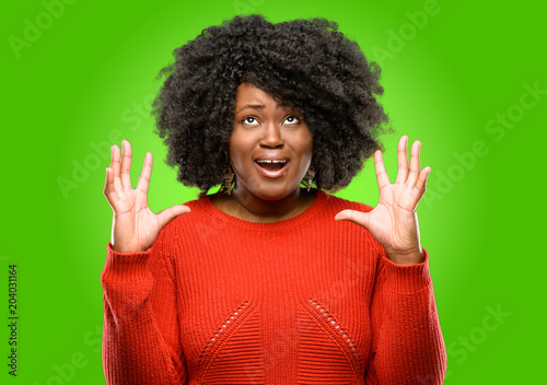 Beautiful african woman terrified and nervous expressing anxiety and panic gesture, overwhelmed