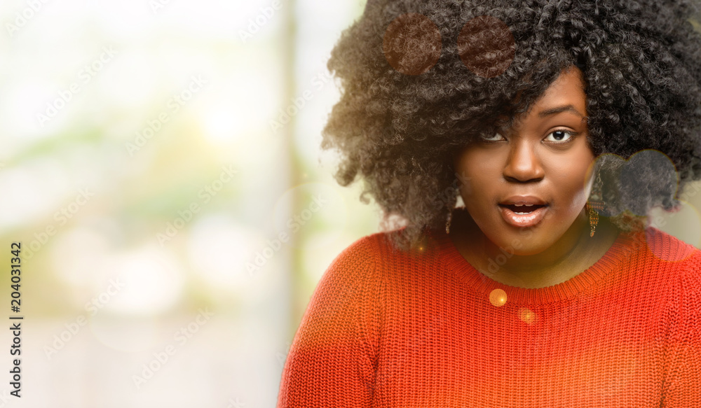 Beautiful african woman scared in shock, expressing panic and fear, outdoor Beautiful african woman scared in shock, expressing panic and fear, outdoor