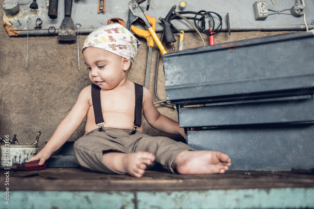 Mechanic Baby Boy Sitting at the shop table with head bandana