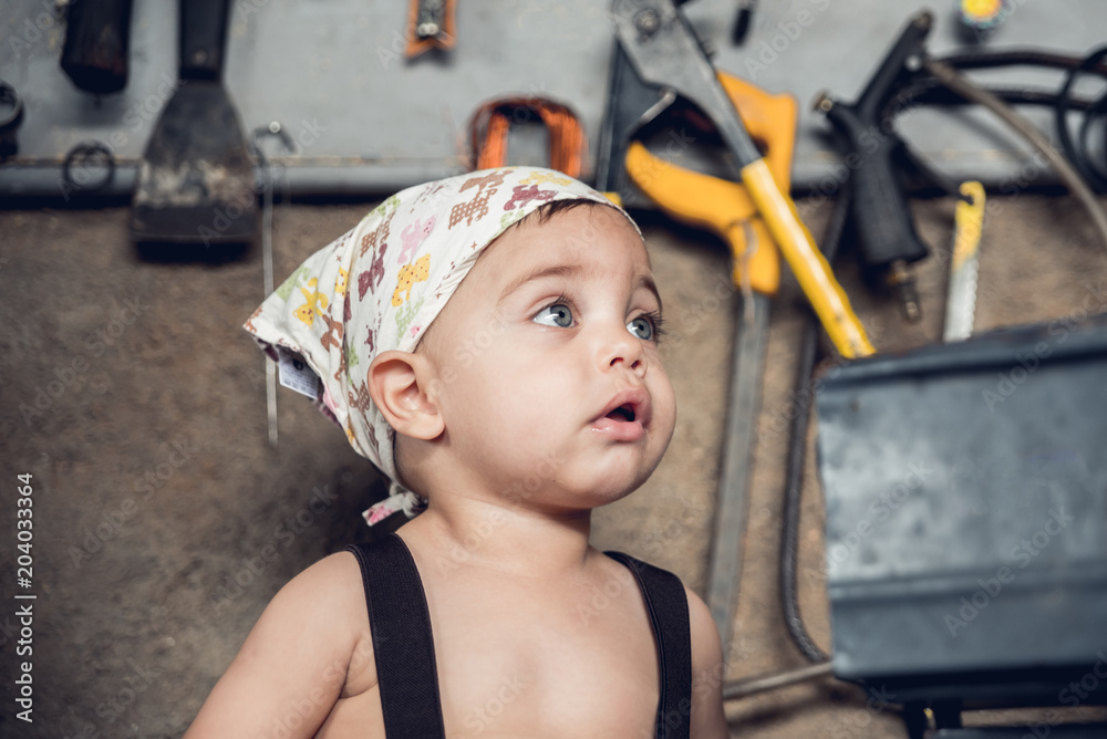 Mechanic Baby Boy - Sitting at the shop table, with head bandana Stock  Photo | Adobe Stock