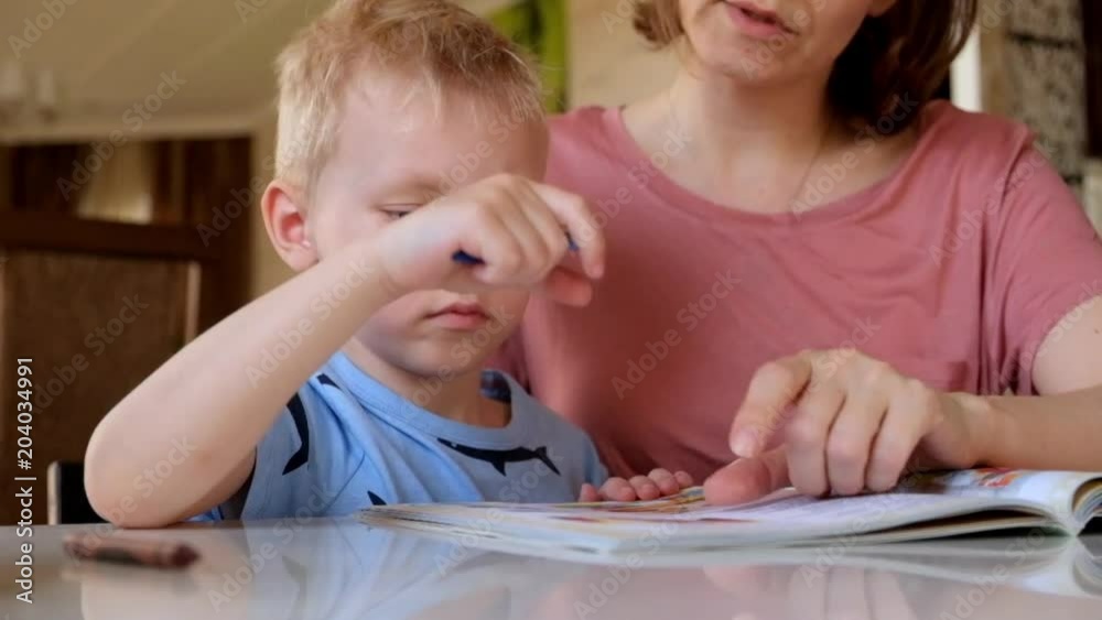 Little boy reading a book with his mother Little boy reading a book with his mother